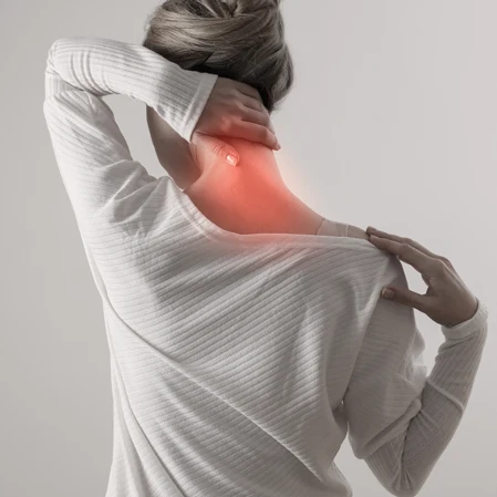 Woman holding her neck in pain.