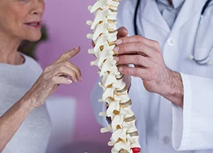 Chiropractic Pooler GA Spine Chiropractor showing a patient a spine.